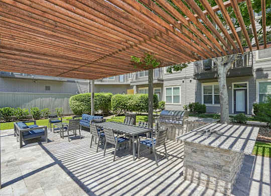 Outdoor grilling patio with dining area and pergola at Highline Urban Lofts Apartments, Cypress, TX 77429
