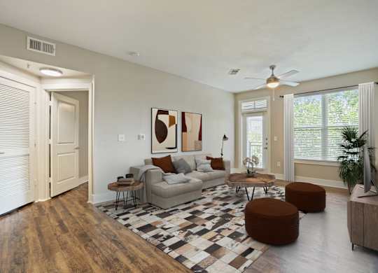 Open concept living room with modern furnishings and vaulted ceiling at Highline Urban Lofts Apartments, Cypress, Texas
