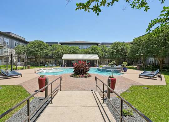 Resort style pool courtyard with pavilion and lounge seating at Highline Urban Lofts Apartments, Cypress, Texas