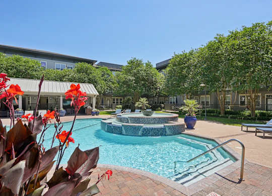 Resort style pool with fountain and surrounding courtyard at Highline Urban Lofts Apartments, Texas