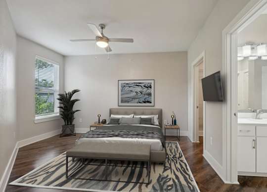 Spacious bedroom with hardwood floors and ensuite bathroom at Highline Urban Lofts Apartments, Cypress, 77429