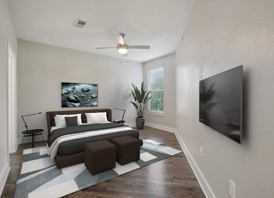Modern bedroom with mounted tv and wood flooring at Highline Urban Lofts Apartments, Cypress, TX