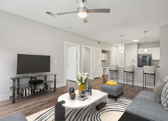 Open living room with kitchen island and bar seating at Highline Urban Lofts Apartments, Texas, 77429