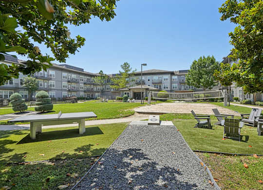 Courtyard with bocce ball court and adirondack chairs at Highline Urban Lofts Apartments, Cypress, TX