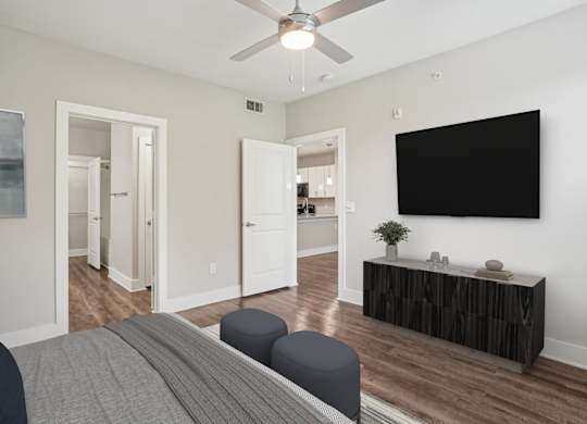 Bedroom with wall mounted tv and media console at Highline Urban Lofts Apartments, Texas