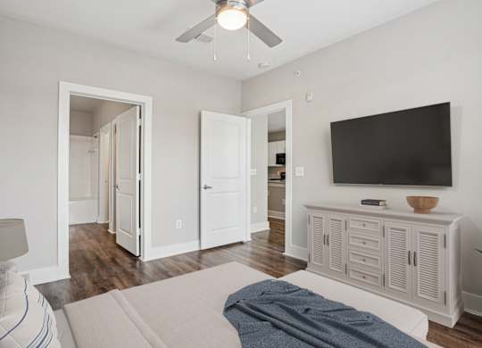 Bedroom with ceiling fan and white dresser at Highline Urban Lofts Apartments, Cypress, TX 77429