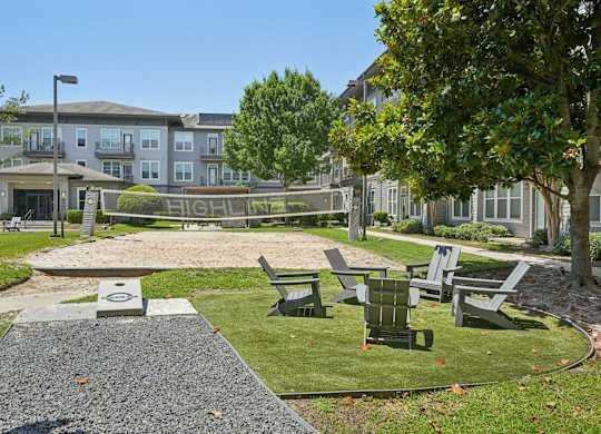 Outdoor recreation area with volleyball court and seating at Highline Urban Lofts Apartments, Cypress, TX