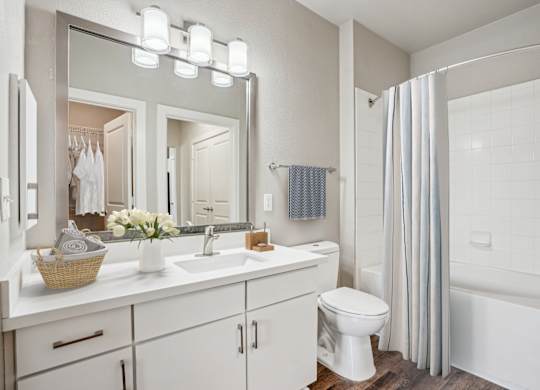 Bathroom with white vanity and tub shower combo at Highline Urban Lofts Apartments, Cypress, 77429