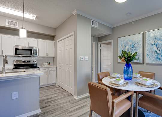Dining area with kitchen and vaulted ceiling at Carmel Creekside Apartments, Fort Worth, Texas