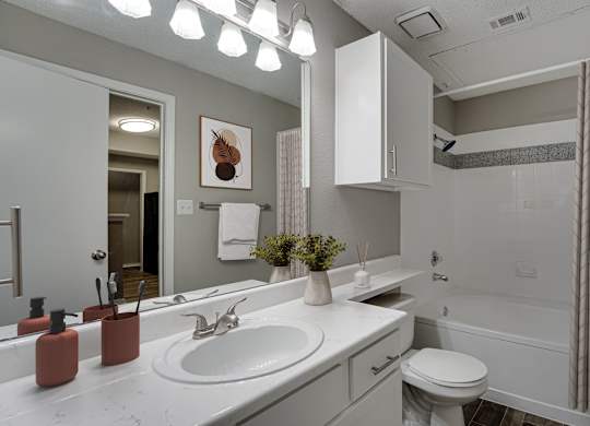 Full bathroom with tub shower combo and vanity at Carmel Creekside Apartments, Fort Worth, Texas