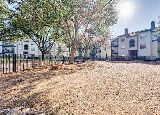 Community dog park with gravel ground and fencing at Carmel Creekside Apartments, Fort Worth, Texas