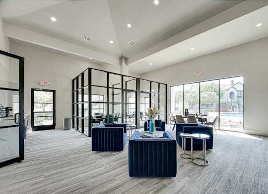 Clubhouse lounge with blue velvet seating at Carmel Creekside Apartments, Fort Worth, 76137