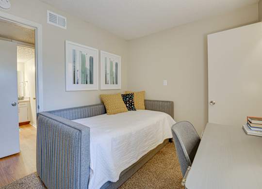 a bedroom with a bed and a desk at Indian Creek Apartments, Texas