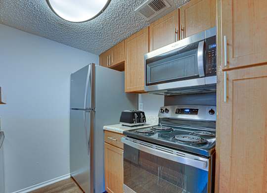 microwave, and refrigerator in kitchen at Timberglen Apartments, Texas, 75287