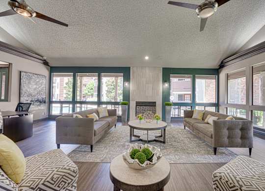 living room with a grey couch at Timberglen Apartments, Dallas