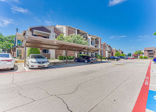 parking lot with cars at Timberglen Apartments, Dallas, TX