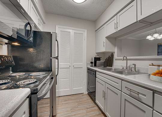 kitchen with a black stove top oven at Timberglen Apartments, Texas, 75287