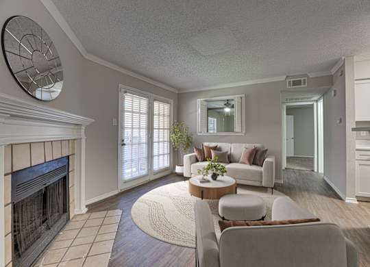 Wall clock and chairs in a room at Timberglen Apartments, Texas