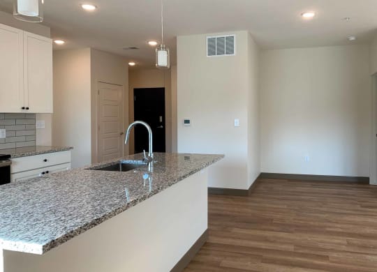 a kitchen with a large island with a sink