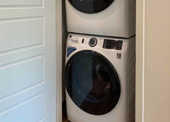 a stackable washer and dryer in a closet