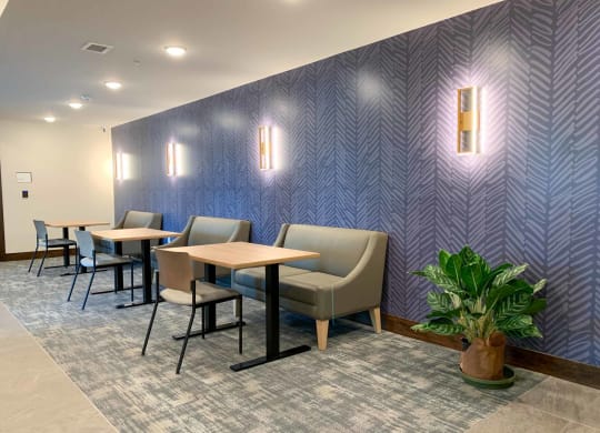 The coffee lounge with booths and tables with a patterned wall