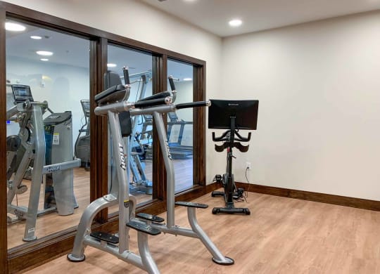 A spin studio with a window to the main gym