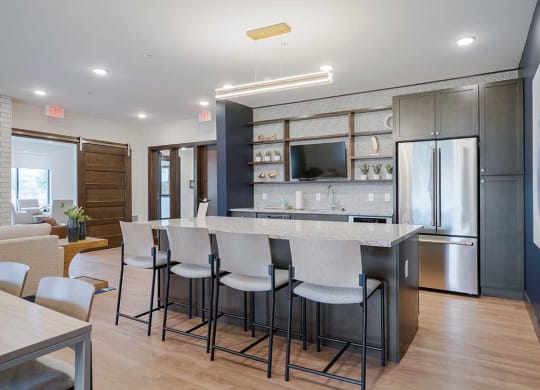 a kitchen with a large island with bar stools
