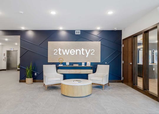 a lobby with a blue accent wall and a sign that says 2twenty2