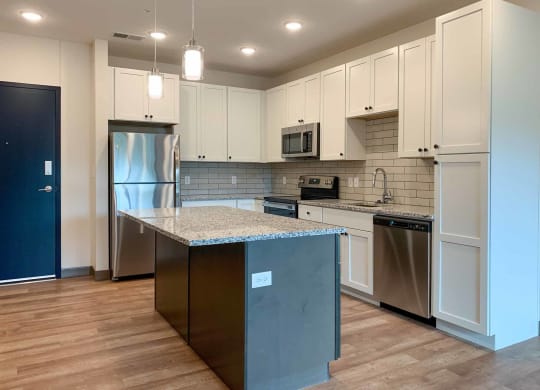a kitchen with stainless steel appliances and white cabinets