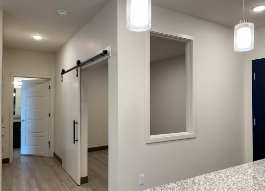 a den with a sliding door and a small window