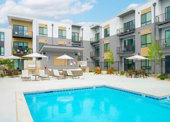a swimming pool in front of some apartment buildings