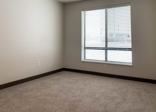 a bedroom with a large window