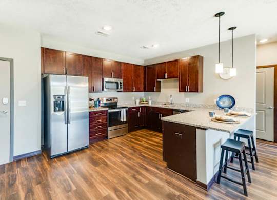 A kitchen with wooden floors and a white island.