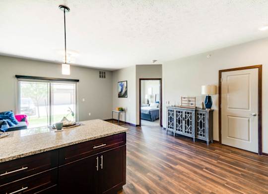 A kitchen with dark wood floors and cabinets.