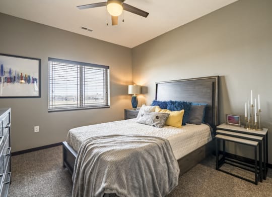 Bedroom with ceiling fan and natural lighting at 360 at Jordan West best new apartments West Des Moines IA 50266