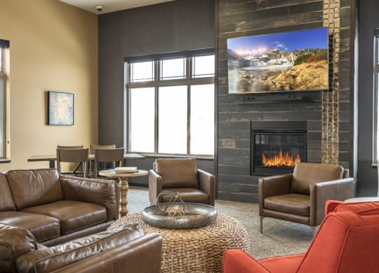 Clubhouse TV lounge area with leather couches at 360 at 360 at Jordan West best new apartments West Des Moines IA 50266