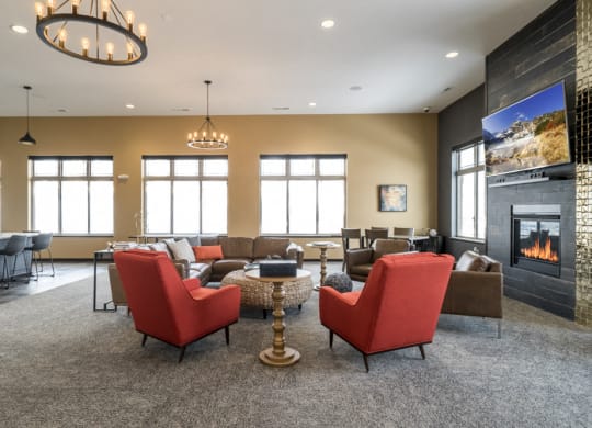 Clubhouse interior with seating, TV and fireplace at 360 at Jordan West best new apartments West Des Moines IA 50266