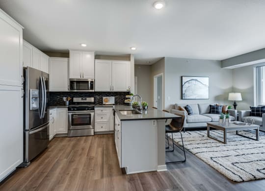 Spacious kitchen with quartz counter tops and spacious living area of 2 bedroom apartment for rent at Ascend at Woodbury best new apartments Woodbury MN 55129