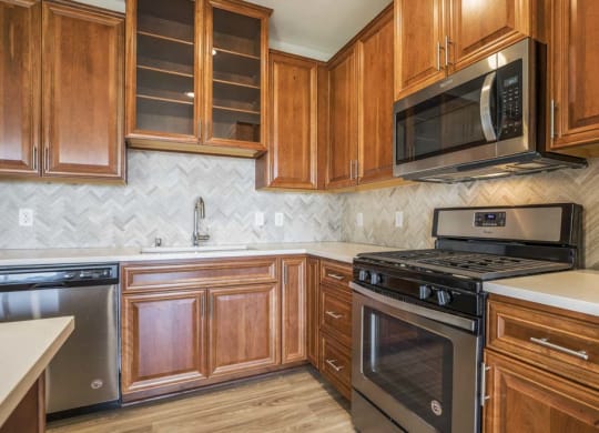 Premium design scheme with custom cabinetry and herringbone backsplash at Ascend at Woodbury MN 55129 new luxury apartments
