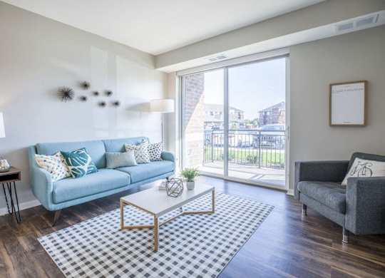 apartment living room with a blue couch and a glass sliding door