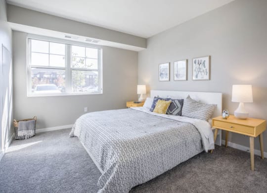 Bedroom with large windows at Ascend at Woodbury new luxury apartments in Woodbury MN 55129