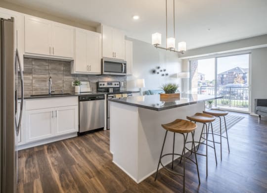 Kitchen with pendant lighting and island at Ascend at Woodbury new luxury apartments in Woodbury MN 55129