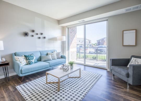apartment living room with a blue couch and a glass sliding door