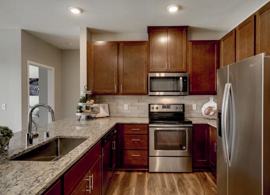 Luxury apartment with dark cabinetry and granite countertops at Ascend at Woodbury MN 55129 new luxury apartments