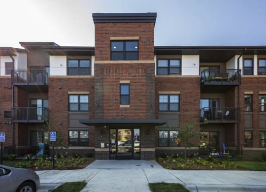 Exterior building view with controlled access entry at Ascend at Woodbury MN 55129 new luxury apartments