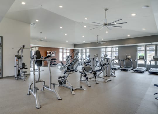 Large fitness center with free weights, weightlifting machines and cardio equipment at Ascend at Woodbury MN 55129 new luxury apartments