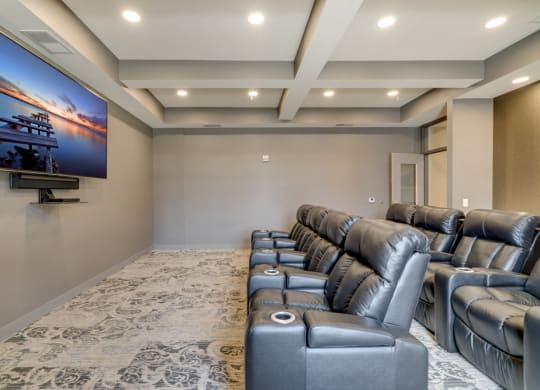 Theater room with leather seating and large TV at Ascend at Woodbury MN