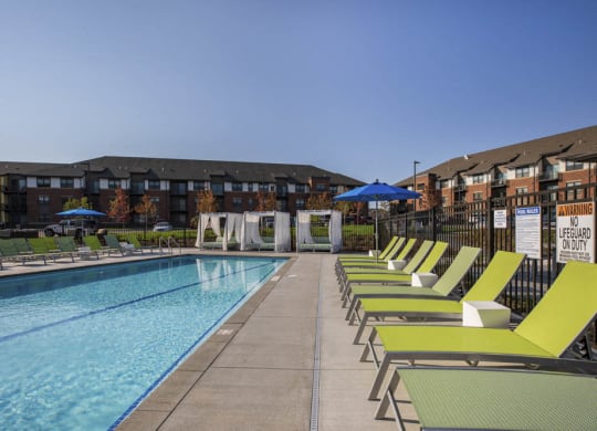 Outdoor swimming pool with cabanas and lounge chairs at Ascend at Woodbury MN 55129 new luxury apartments