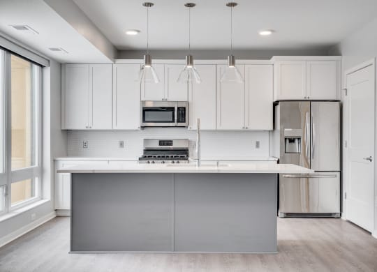 Beautiful kitchen with light luxury finishes, matching stainless steel appliances, and granite countertops