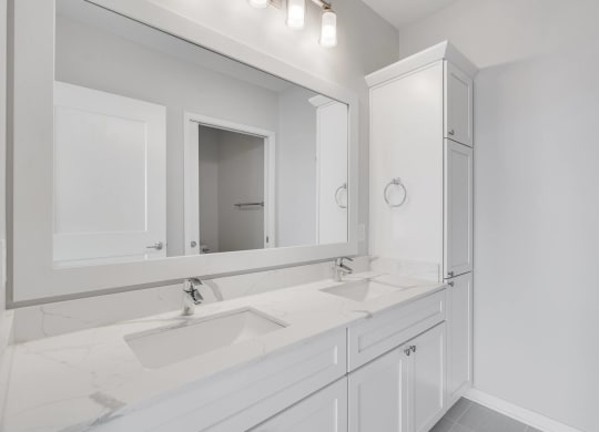 Large dual sink vanity in luxury bathroom at Aspire at CityPlace in Woodbury, Minnesota